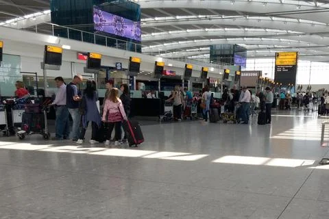 A Queue Of People Waiting To Check In For Their Flight At Heathrow Terminal 5. T Stock Photos