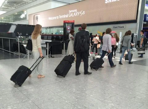 A Queue Of People Waiting To Check In For Their Flight At Heathrow Terminal 5. T Stock Photos