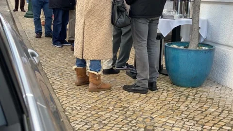 Queue of people waiting in line to be served. The queue of people standing Stock Footage 232360006