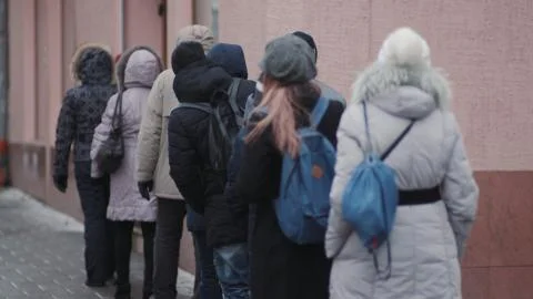 Queue of people waiting in line to store city center winter イラスト素材