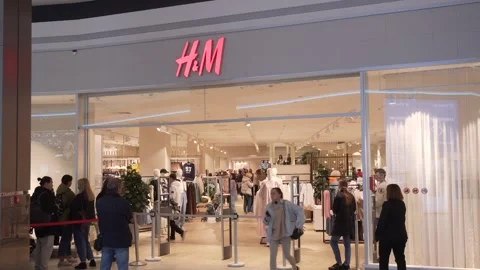 Queue of people waits to enter store during sale, customers inside the store Stock Footage 247687934