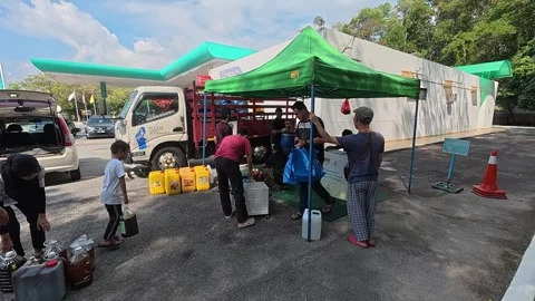 A queue of people waits to sell used cooking oil to a collector. Stock Footage 315688326