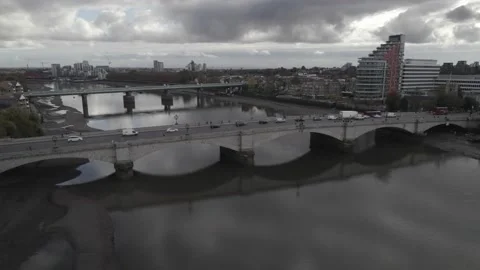 Queue of slowly moving vehicles passing on bridge over water Video stock 167931592