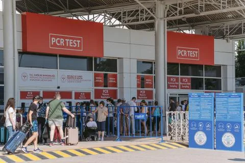 Queue of tourists standing after arrival at PCR test laboratory of airport. Stock Photos
