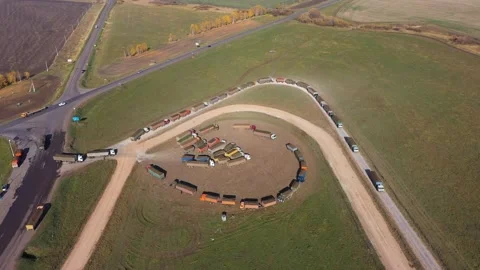 Queue of trucks with sugar beets on the scales of a sugar factory Stock Footage 146106293