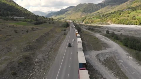 Queue of trucks waiting to pass the Georgian - Russian border in Georgia Stock Footage 162706848