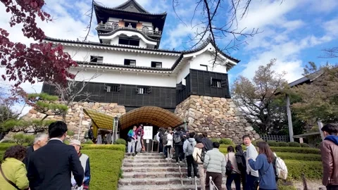 Queue Of Visitors Waiting To Enter the Historic Inuyama Castle on a Bright Day Stock Footage 299624059