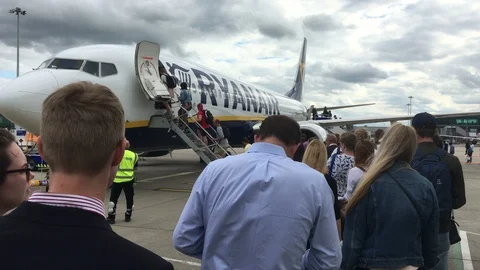 Queue waiting to borad Ryanair 737 at London Stansted airport, Essex, UK Stock Footage 111655983