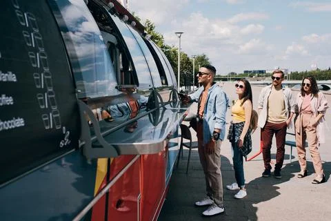 Queue of young customers waiting for end of lunch break of food truck clerks Stock Photos