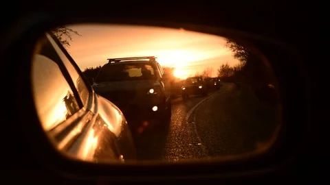 Queuing traffic reflected in vehicle wing mirror at sunrise york united kingdom Stock Footage 121006735