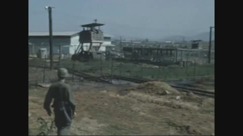 QUI NHON - 1970: Base perimeter - Perimeter wire and a timber guard tower Stock Footage 343937934