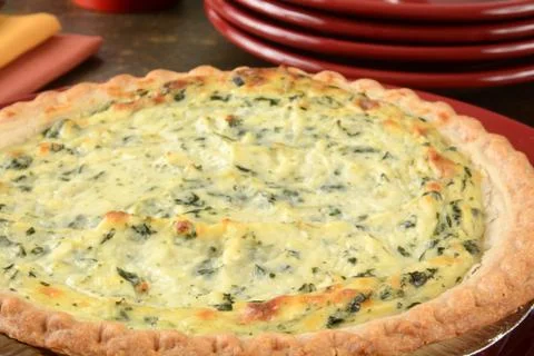 Quiche and serving plates Stock Photos