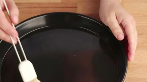 A quiche dish being brushed with soft butter Stock Footage 24669688