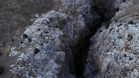 Quick aerial shot of deep narrow gorge, camera fly over and tilt down Stock Footage 100649334