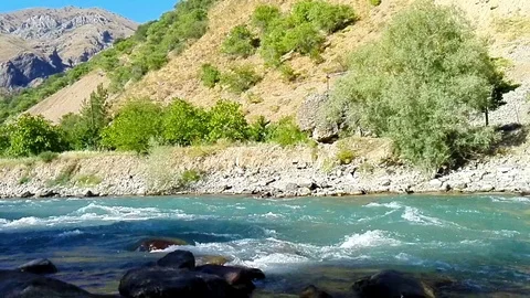 Quick and cool river Ugam in mountain Tashkent Stock Footage 79026486