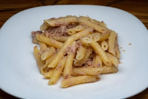 A quick and easy first course: pennette rigate with tuna and lemon. Stock Photos