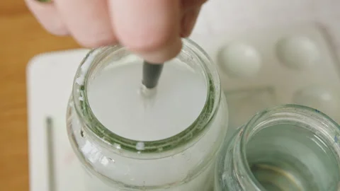 Quick and easy jar water cleaning for your paint brushes at home Stock Footage 321380445