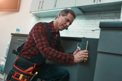 Quick and professional. Man solves household problems 写真素材
