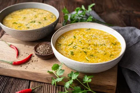 Quick and simple spicy egg drop soup with parsley and chilli Stock Photos