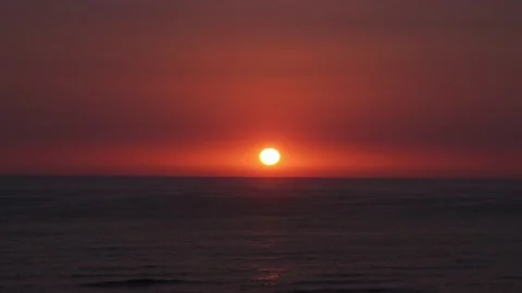Quick camera of a beautiful sunset with the bright yellow round sun hiding in Video stock 194500878