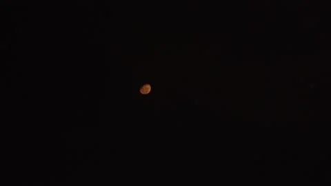 Quick camera of the moon out of focus moving through the night sky. time lapse Stock Footage 194500161