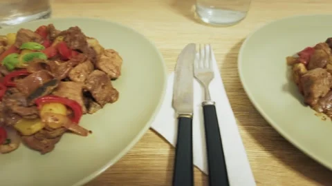 Quick camera move, stir fry beef vegetables, two plates, home couple dinner Video stock 321193473