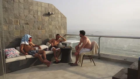 Quick camera of several friends sitting on a terrace talking and drinking beer Stock Footage 192978987