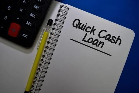 Quick Cash Loan write on a book isolated on Office Desk Fotos Stock