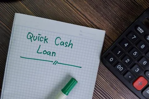Quick Cash Loan write on a book with keywords isolated on Wooden Table. Fotos Stock