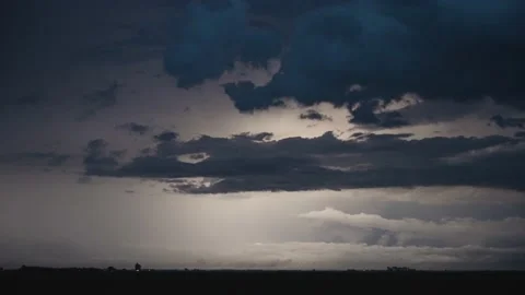 Quick Flashes of Lightning From a Powerful Thunderstorm Light up the Night Sky. Stock Footage 232985292