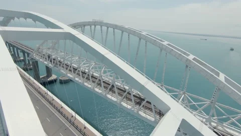 A quick flight between the arches of the Crimean Bridge behind the truck Stock Footage 230156174