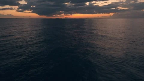 Quick flight towards sunset over endless ocean. Blazing sunset merges with water Stock Footage 275084089
