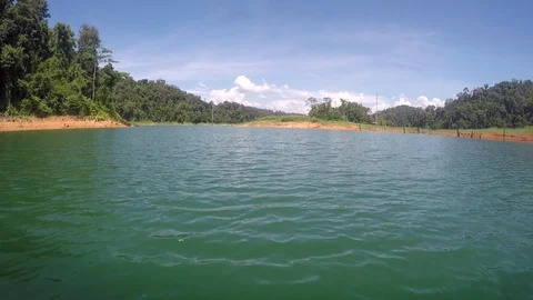 Quick forward shot just above the surface of the lake at tropical rainforest Stock Footage 93876706