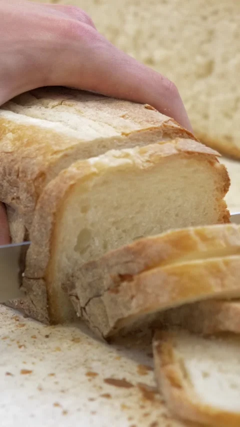 Quick Hands Slicing Bread Loaf for Bruschetta in Restaurant Kitchen Stock Footage 336793750