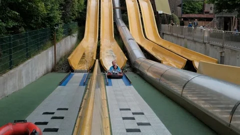 A quick inflatable boat ride down a canal at high speed from a water slide. 動画素材 240467326