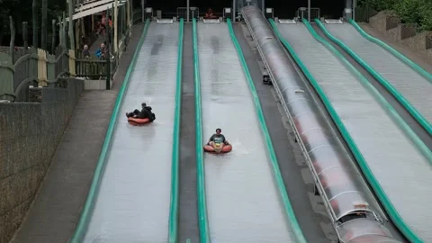 A quick inflatable boat ride down the canal from the water slide Stock Footage 240468166