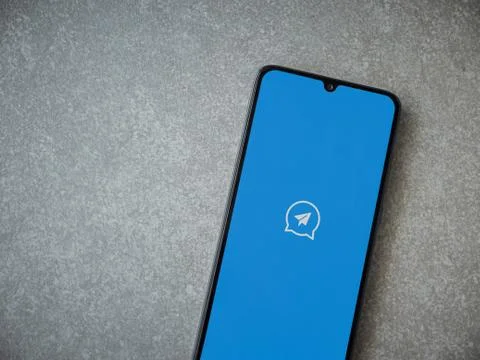 Quick Message app launch screen with logo on the display of a black mobile sm Stock Photos