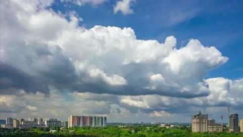 Quick motion of fluffy clouds over the city Stock Footage 205046931