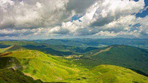Quick motion of fluffy cumulus clouds over mountain valley at summer day Stock Footage 204147690