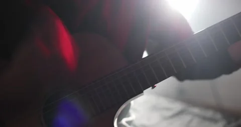 Quick movement of man's hand along strings of guitar, playing in flamenco style 스톡 동영상 179023175