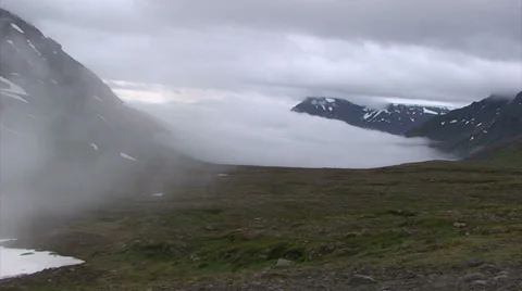 Quick moving cloud incoming into glacial valley with fog Stock Footage 37270058