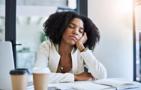 A quick nap to refresh my mind a bit. a young businesswoman taking a nap at her Stock Photos
