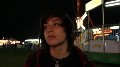Quick pan down to teen at carnival Stock Footage 80326345