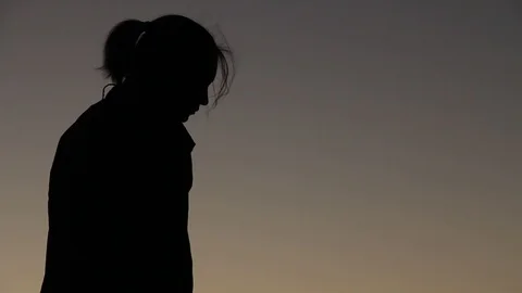 Quick pan up to person watching ocean and then picking up bags to leave Stock Footage 123202039