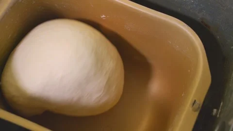 A quick panning show of dough being kneaded in a bread maker. Stock Footage 249807045