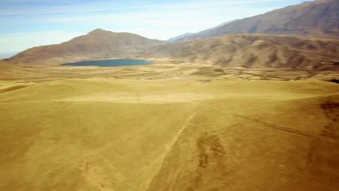 Quick panoramic view of valley with mountain background, cloudy day, aerial shot Stock Footage 89870555