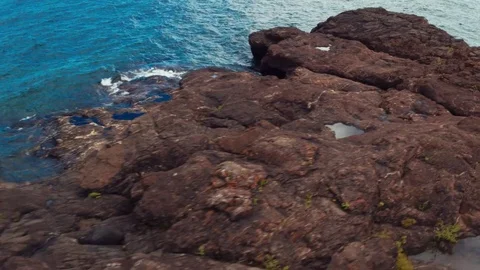 Quick Shoreline Flyby Black Rocks in Michigan Stock Footage 71328154