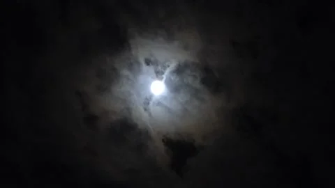 Quick shot of the bright moon at night with the clouds rushing by. time lapse in Stock Footage 194473424