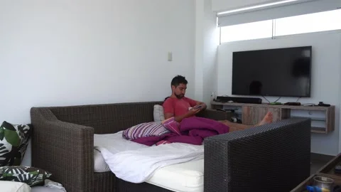 Quick shot of a man sitting in his room drinking coffee in a beach house looking Stock Footage 194473764