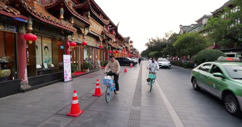 Quick shot of people riding shared bicycles on Qintai Ancient Street 스톡 동영상 321234638